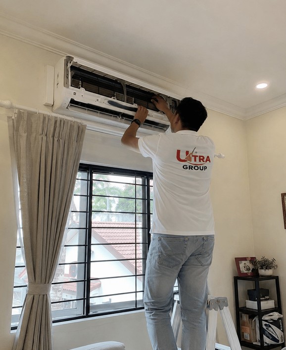 Aircon Care technician servicing an air-conditioner